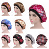 A collection of satin sleep bonnets in various floral, leopard print, and plaid patterns displayed on a mannequin head.