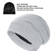 A light gray satin sleep bonnet rolled up, showing the smooth texture of the fabric.