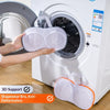 A hand places a mesh laundry bag for bra support into the drum of a white washing machine.