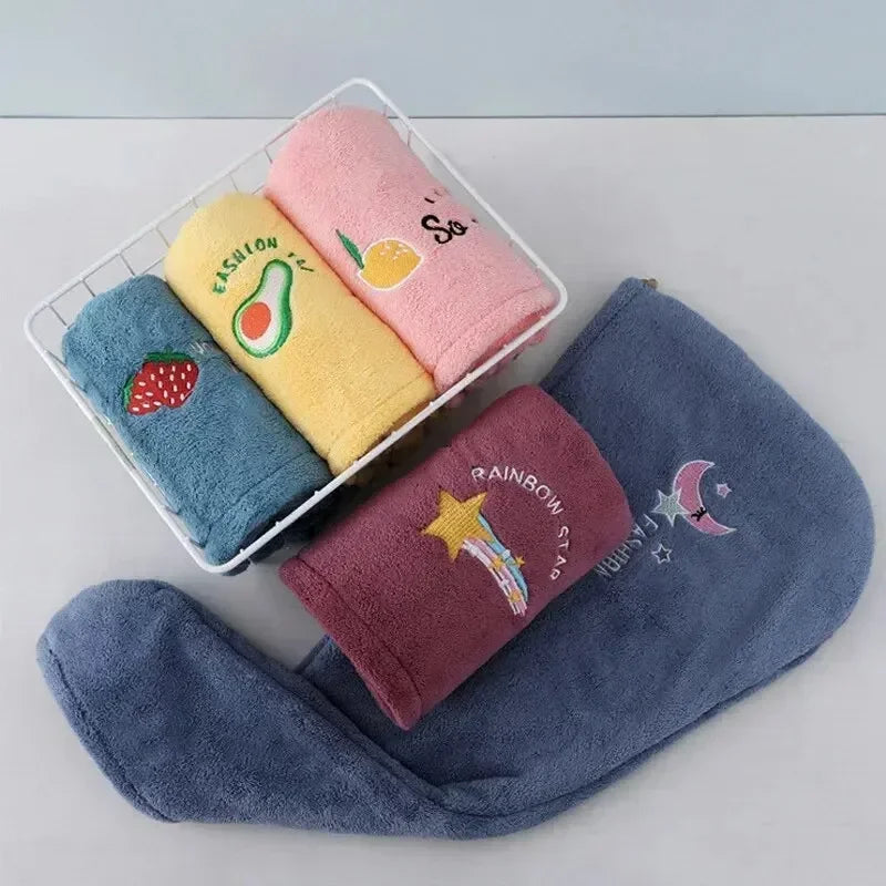 A white basket holds several pink and yellow soft absorbent hair towels with fruit designs.