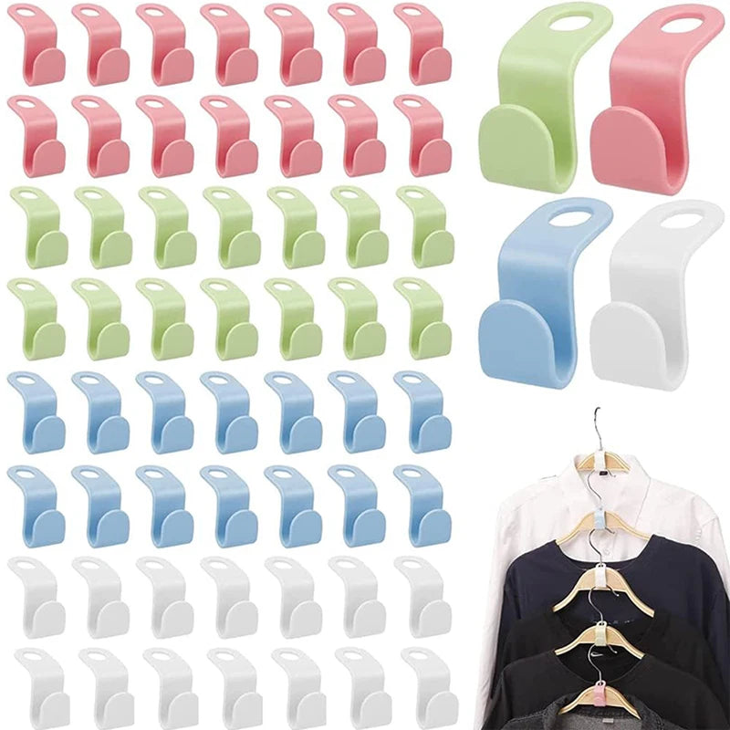 A collection of pink, green, and light blue space-saving hanger connector hooks for closet organization.