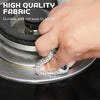 A hand is holding a silver, textured cleaning cloth attached to a rotating disc of a kitchen tool.