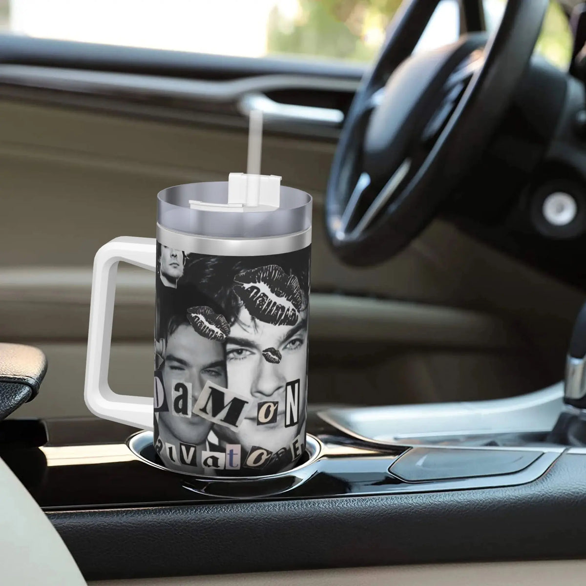 A silver tumbler with a straw featuring a close-up portrait of a man and the text DAMON