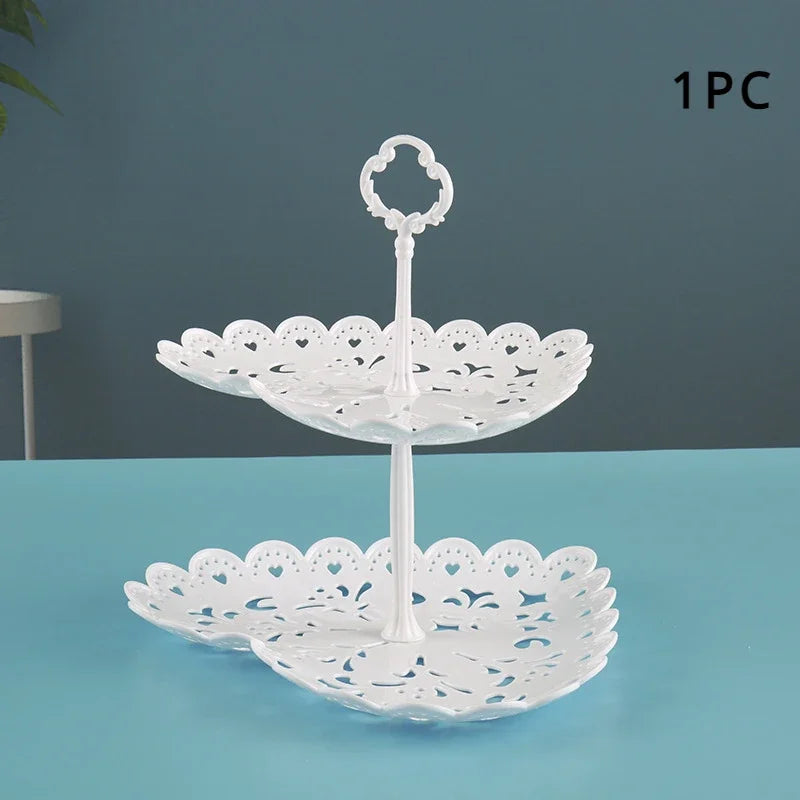 White plastic multi-use dessert stand with a scalloped plate and a looped handle