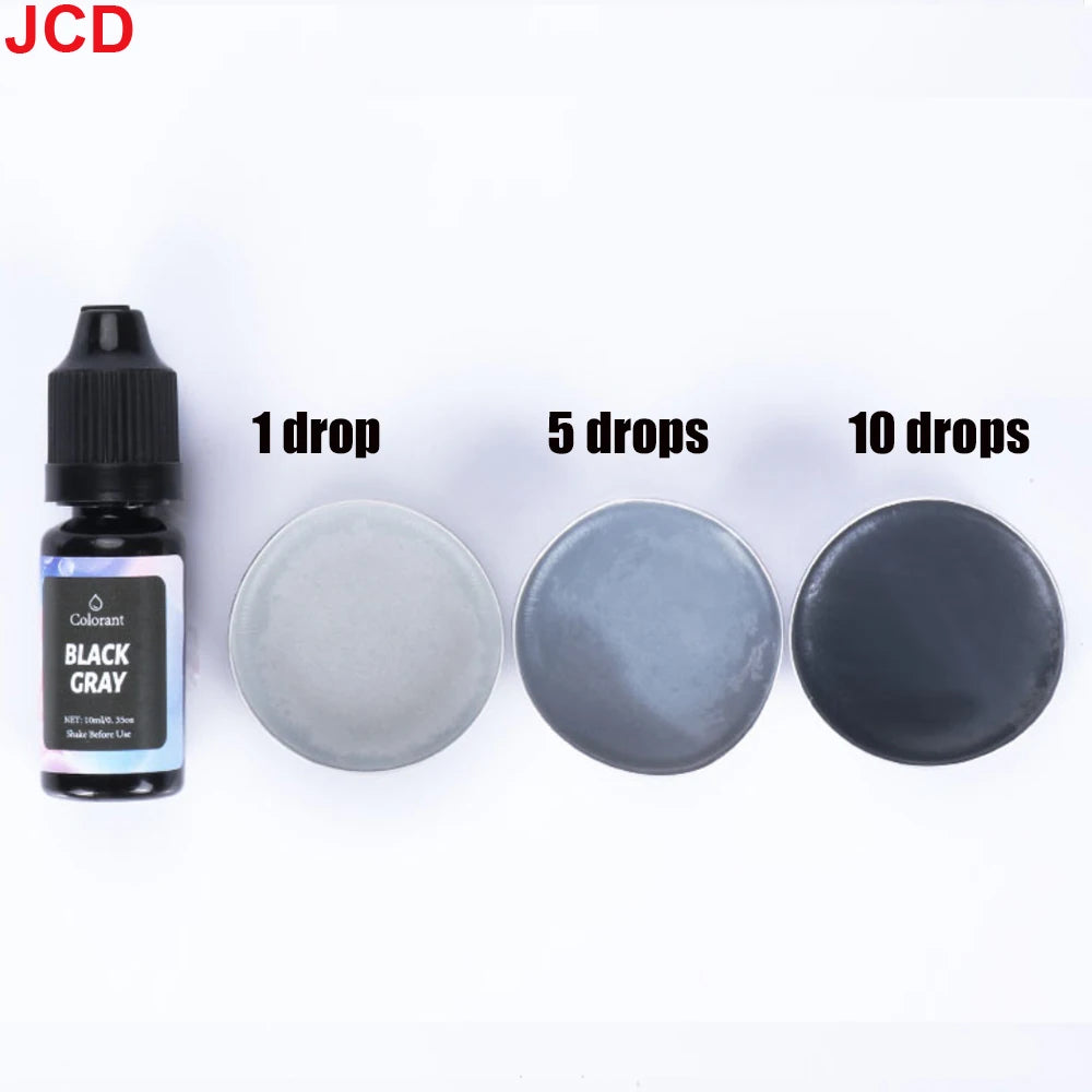 A set of black gray liquid candle dye in dropper bottles, showing 1, 5, and 10 drops on a white surface.