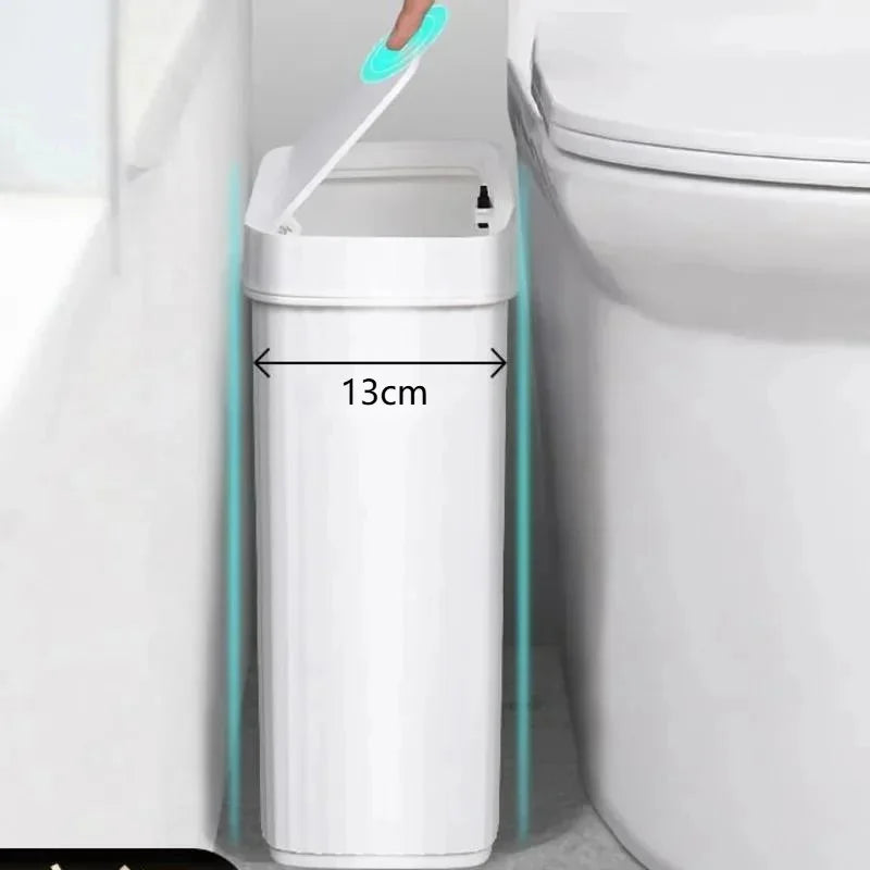 A slim white bathroom trash can with a press-fit lid is shown next to a toilet.