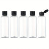 A set of four clear glass refillable travel bottles with black caps and a black pump top.