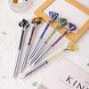 A collection of natural amethyst crystal pens with various colored crystals displayed on a white surface.