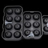 A set of black silicone sphere ice molds for whiskey and cocktails, displayed in a packaging tray.