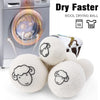 A set of six white wool drying balls next to a laundry machine, demonstrating how they make clothes dry faster.
