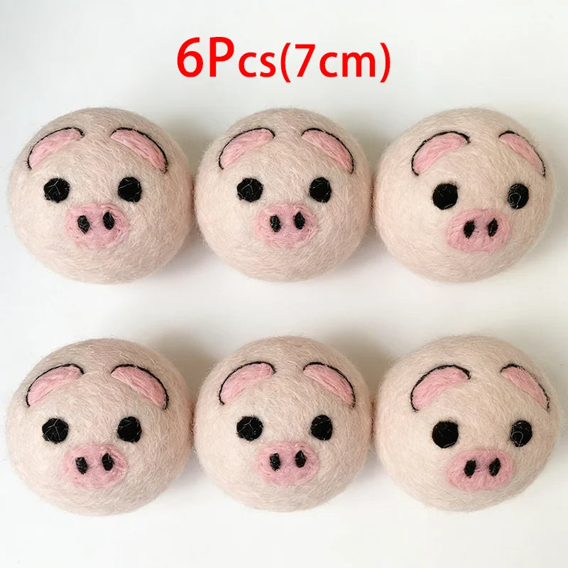 Six soft pink wool dryer balls shaped like pigs, measuring 7cm each.