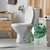 A white ceramic toilet with a green bolt cover is shown next to a wooden shelf and a woven basket.