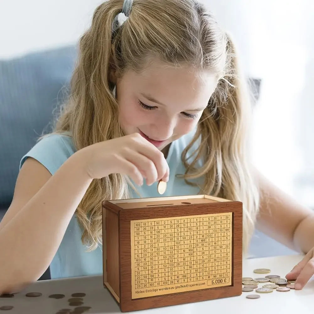 A young girl is using a reusable wooden piggy bank to save money, with coins scattered nearby.