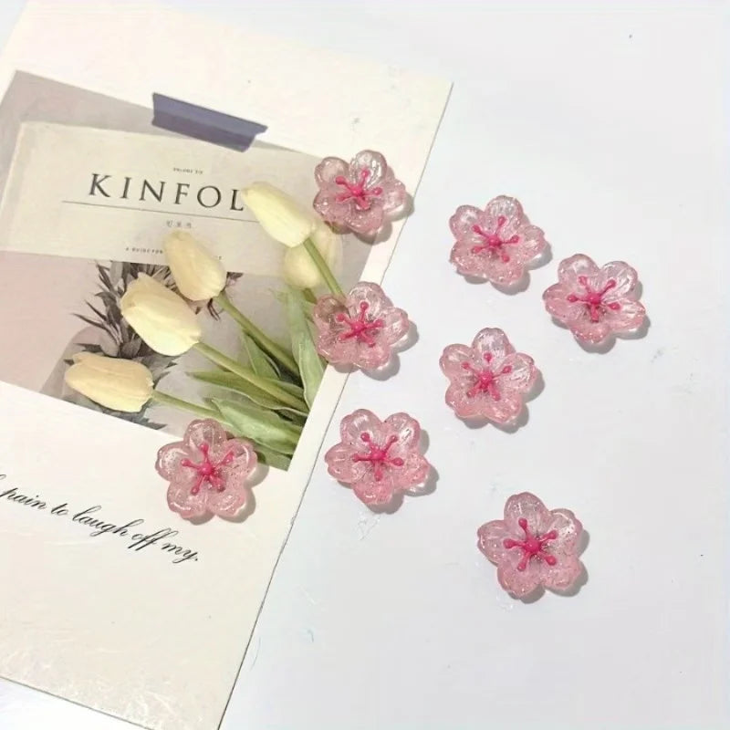 Un juego de imanes de flor de cerezo rosa exhibidos sobre un fondo blanco.