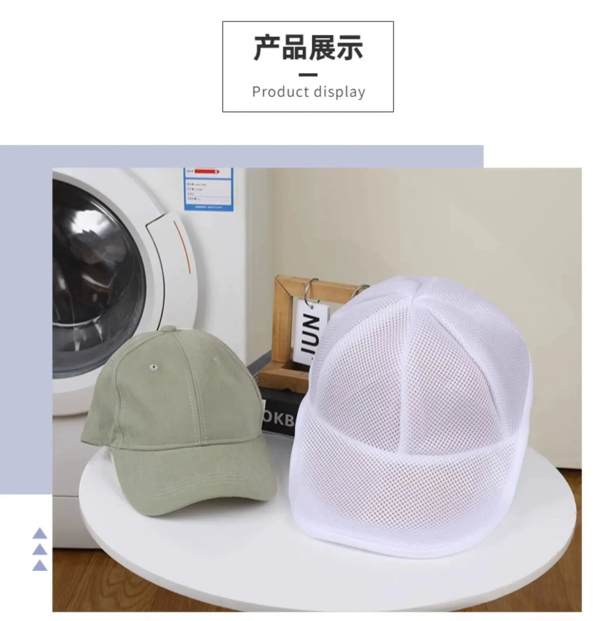 A white mesh reusable laundry bag is displayed on a white surface next to a green baseball cap.