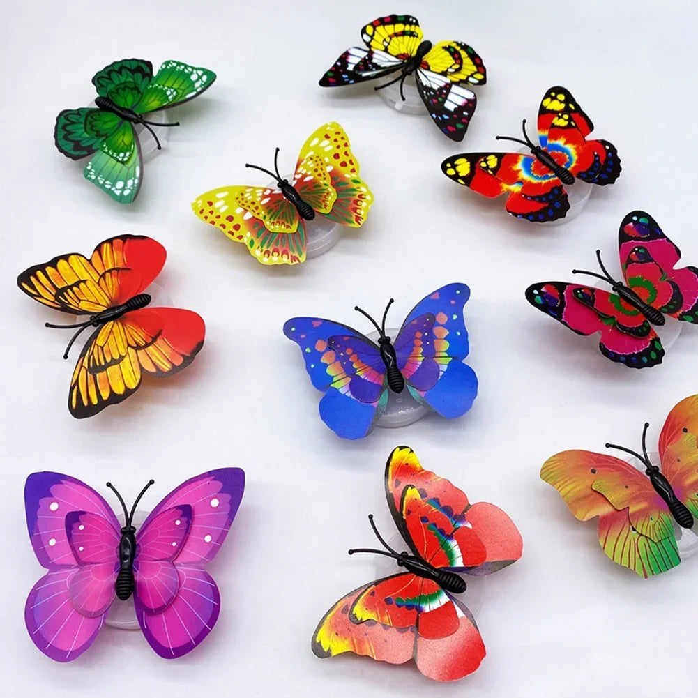 A collection of colorful, luminous 3D butterfly wall lights in various shades of green, yellow, orange, pink, and red.