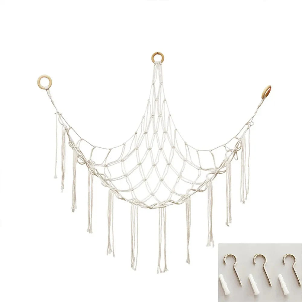 A white mesh hammock storage net with hanging strands and circular rings.