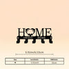 Black rustic metal wall hook key holder with the word HOME engraved on it
