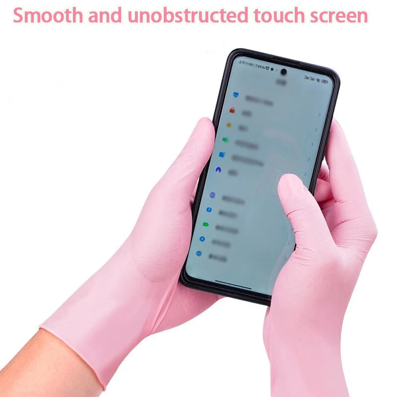 Hands wearing pink nitrile gloves touching a smartphone screen.