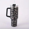 A black and silver leopard print insulated stainless steel tumbler with a handle and straw.
