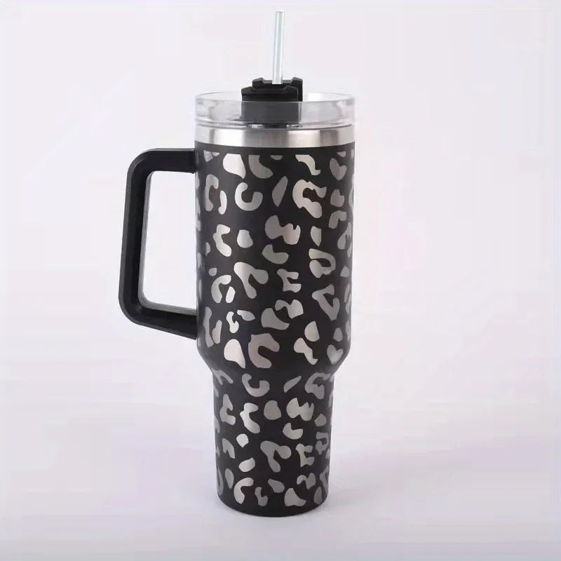 A black and silver leopard print insulated stainless steel tumbler with a handle and straw.