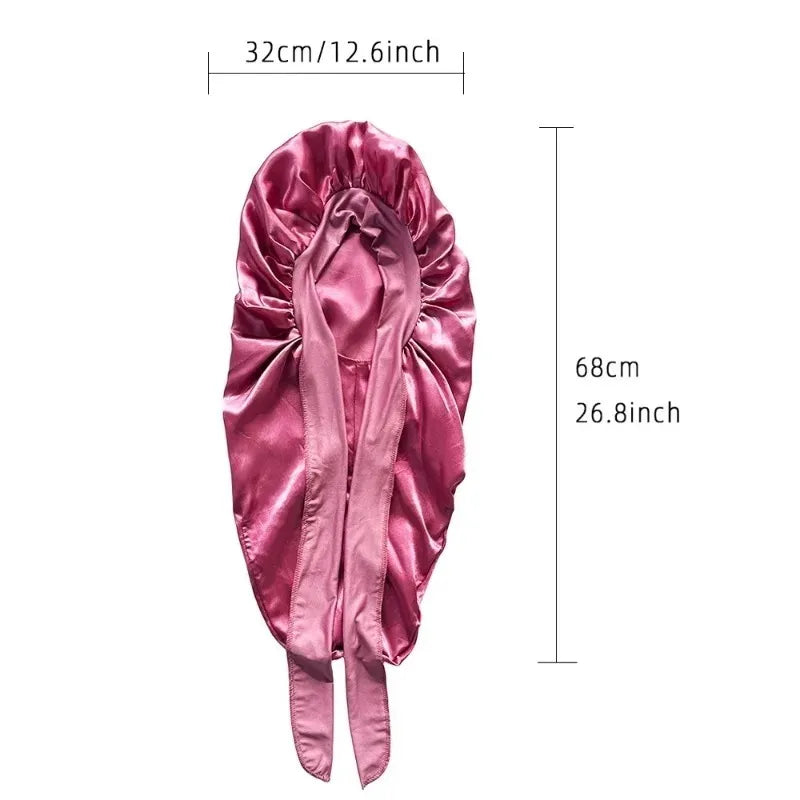 A pink satin sleeping bonnet designed for curly hair.