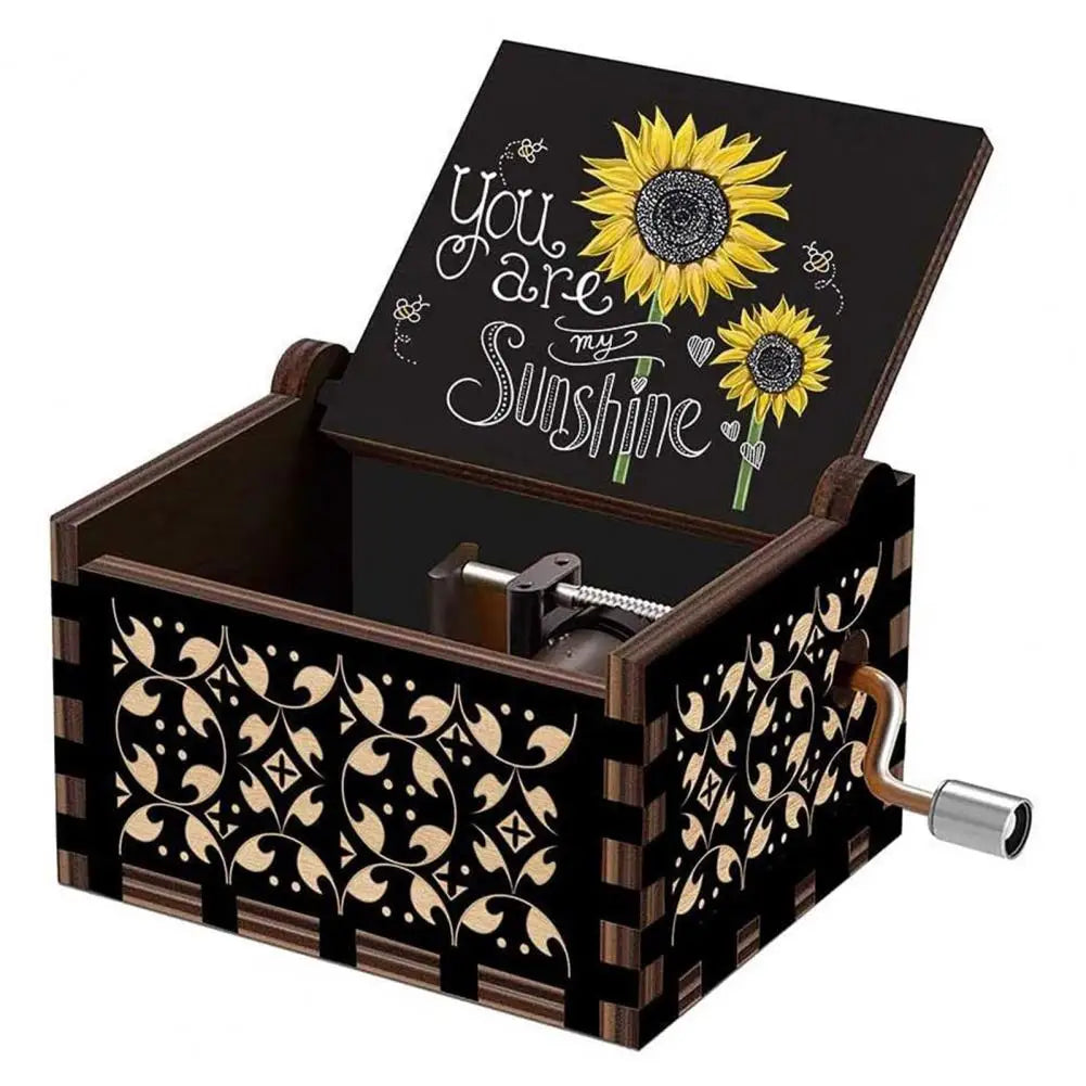 A dark wooden music box with a lid featuring a sunflower design and gold hardware.