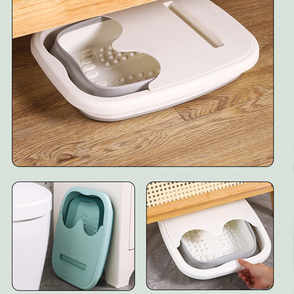 A portable foldable foot bath tub in light gray and white is shown being used on a wooden floor.