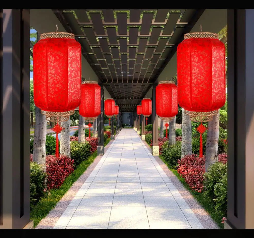 A row of red Chinese lanterns hangs from a pergola walkway lined with greenery and stone pillars.
