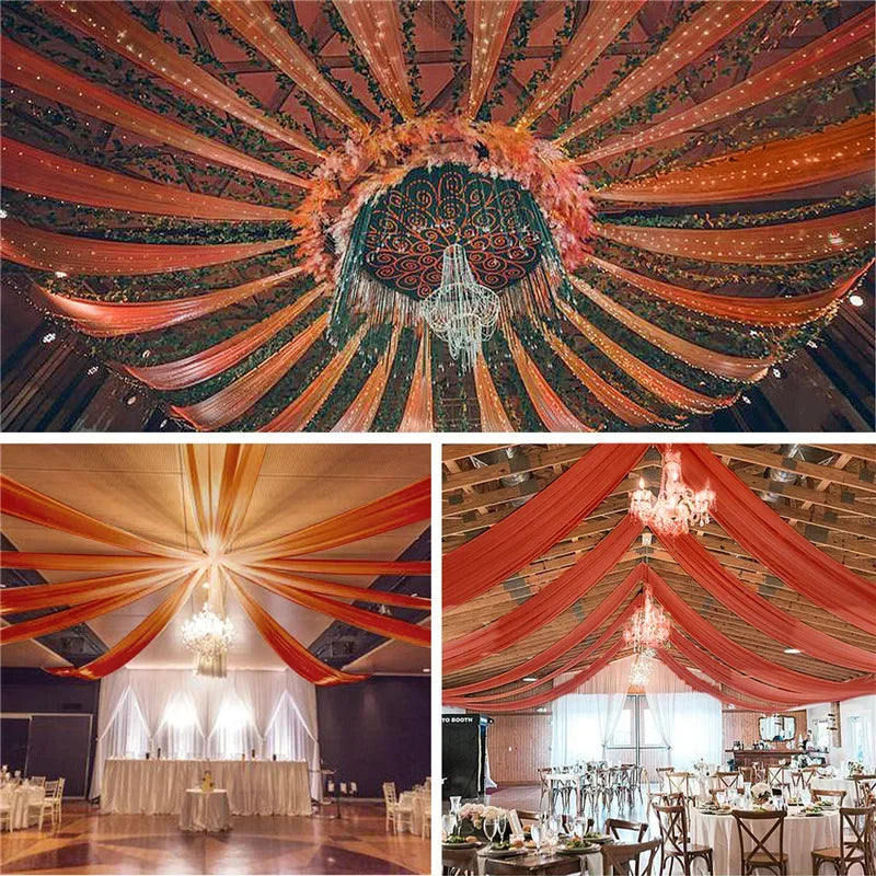 An overhead view of a richly draped ceiling using sheer chiffon fabric in shades of orange, green, and gold for an event.
