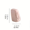 A pink silicone toothbrush head cover shown next to a measurement scale.