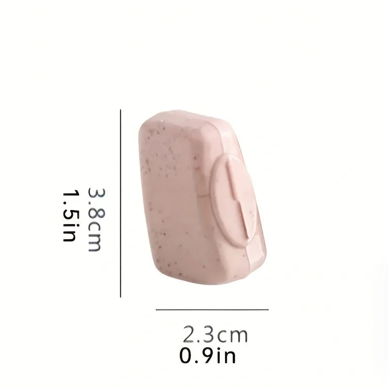 A pink silicone toothbrush head cover shown next to a measurement scale.