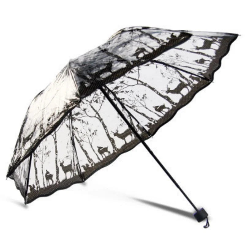 A black and white patterned retro transparent folding umbrella open against a white background.