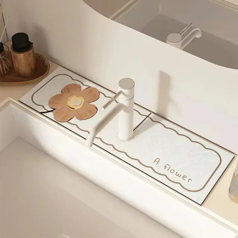 A white faucet mat with a flower design and a wooden flower accent placed in a bathroom sink.