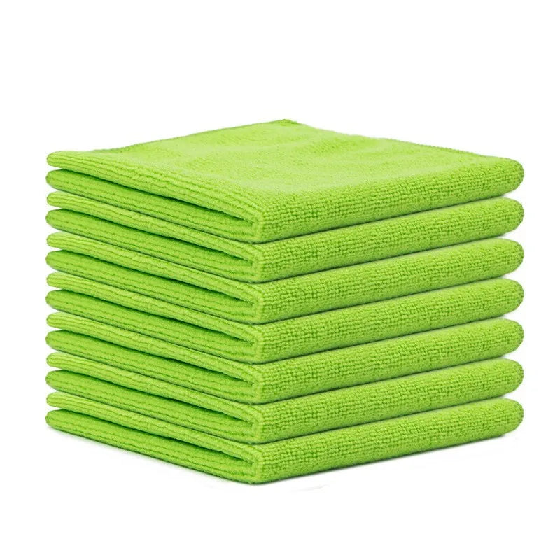 A stack of ten bright lime green reusable microfiber cleaning cloths.