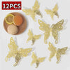 A set of twelve gold-colored 3D decorative butterfly wall stickers displayed next to a slice of lemon and a round object.