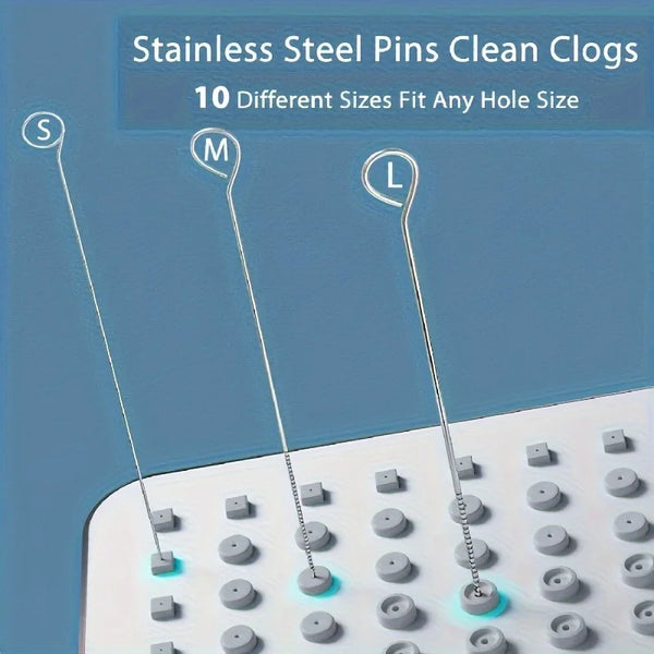 Stainless steel pins for cleaning clogs in sizes S, M, and L shown next to a white cleaning mat.