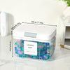 A clear plastic container holding colorful laundry pods with a silver lid and measurement markings.