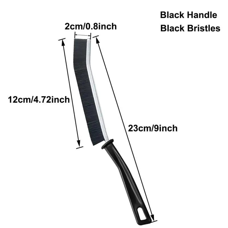 A black crevice cleaning brush with a black handle and bristles shown in a vertical view.