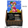 A wooden box containing a musical tone box with an anime character illustration and the title Catch You Catch Me