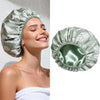 A close-up of a woman wearing a green satin lined reusable shower cap.
