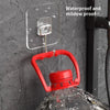 A red rotating wall hook is attached to a clear adhesive plate on a dark gray textured wall.