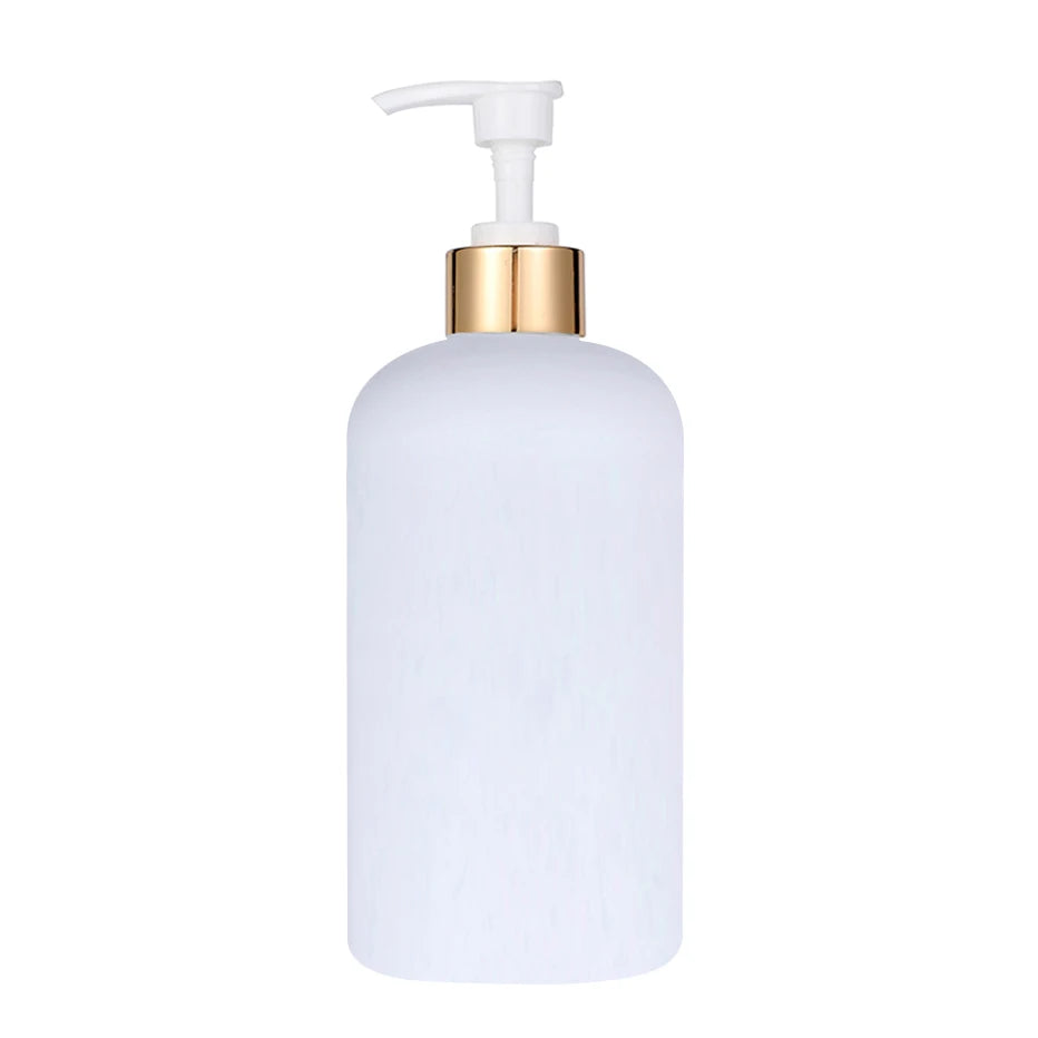 A white refillable pump soap dispenser bottle with a gold-colored pump top.