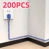 A blue adhesive cable clip is shown running from a power outlet to the floor, demonstrating cable management.