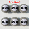 Six grey wool dryer balls shaped like pandas with black eyes and nose.