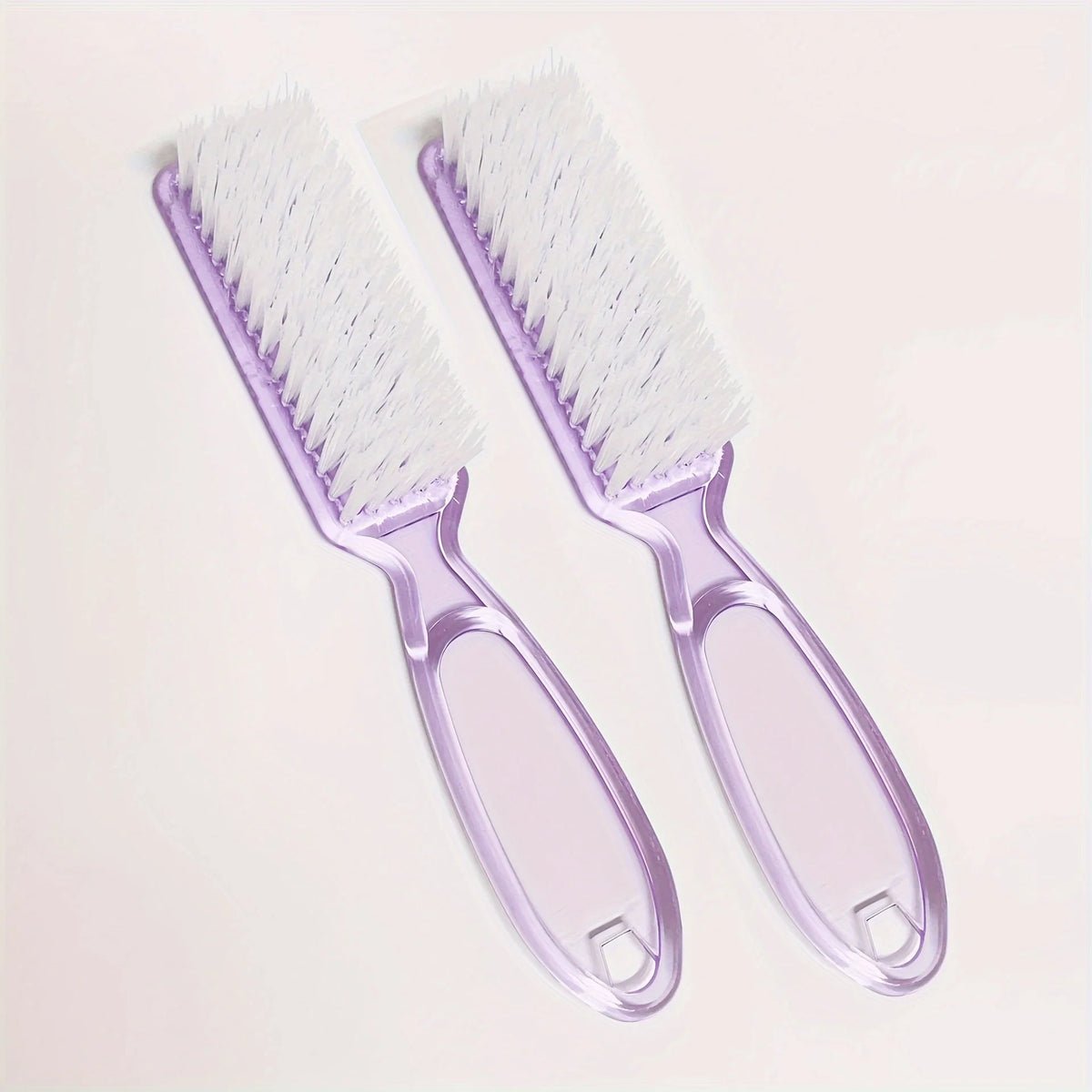 A pair of light purple multi-purpose nail art and dust cleaning brushes are shown against a white background.