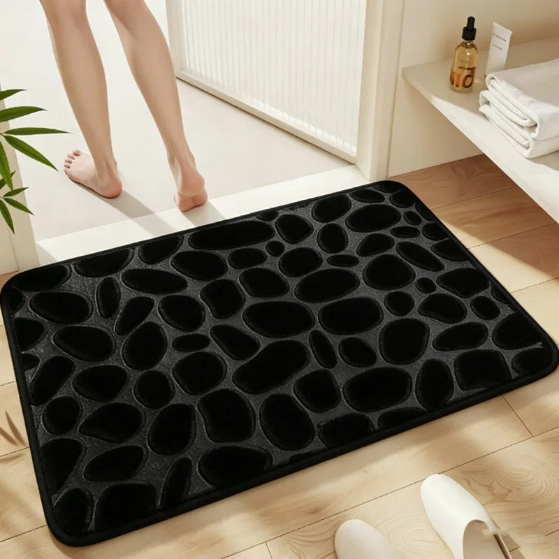 Black soft pebble embossed bathroom rug used on a wooden floor.