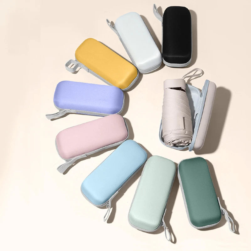 A collection of colorful compact 5-fold travel umbrellas displayed on a light background.