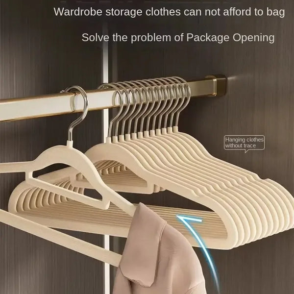A close-up of a light beige stainless steel non-slip hanger rack inside a closet, showing clothes hanging on the hangers.