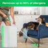 A person is using a green mop to clean a floor with white pads, demonstrating the product's allergen removal capability.